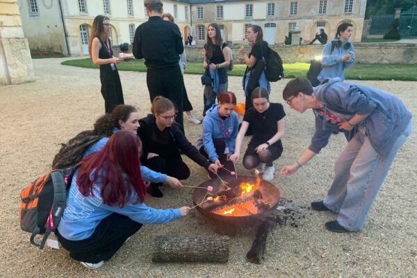 Students Roast Marshmallows Over A Firepit