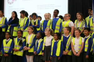 Children In High Vis Vest Sing