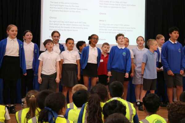 children sing in a large group